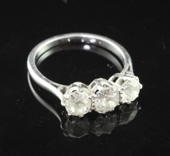 A mid 20th century white gold and three stone diamond ring, size J.